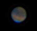 mars Colorful blurred image of a planet against a dark background.