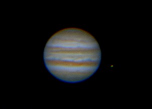 Jupiter with the Moon IO Jupiter with its striped atmosphere and a small moon nearby.
